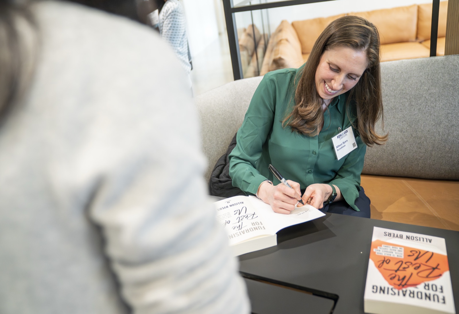 Allison signing copies of Fundraising for the Rest of Us for readers